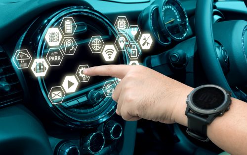 Smart car and internet of things (IOT) concept. Finger point to car 's console and icons popup out of screen.