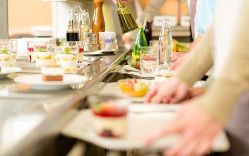 Desserts at cafeteria people with serving tray self service canteen